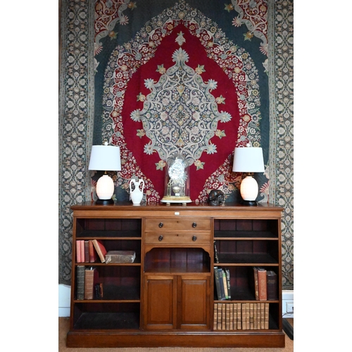 853 - A Victorian mahogany low open bookcase, centred by two long drawers over an open niche and pair cupb... 