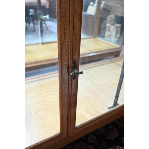 859 - A pair of 1930's oak framed glazed retailers display counters, with three doors to verso, no shelves... 