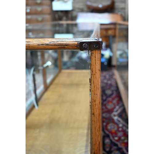 859 - A pair of 1930's oak framed glazed retailers display counters, with three doors to verso, no shelves... 