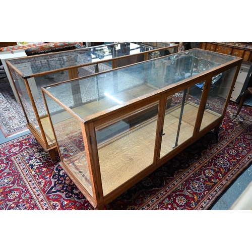 859 - A pair of 1930's oak framed glazed retailers display counters, with three doors to verso, no shelves... 