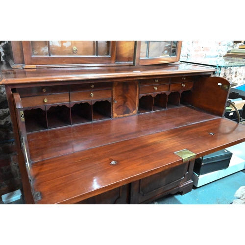 860 - A George III mahogany secretaire / bookcase, the (associated) astragal glazed upper part enclosing s... 