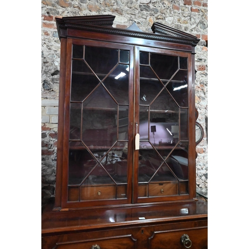 860 - A George III mahogany secretaire / bookcase, the (associated) astragal glazed upper part enclosing s... 