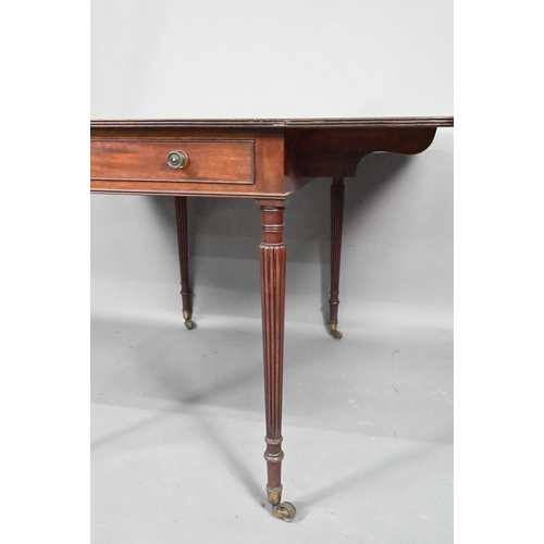 872 - A Regency mahogany drop leaf Pembroke table, the top with round corners and reeded edge, raised over... 