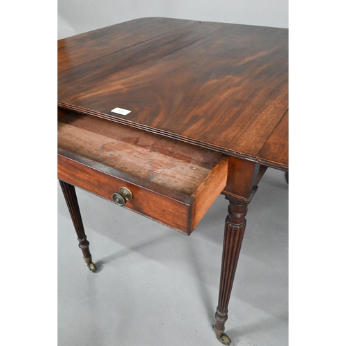 872 - A Regency mahogany drop leaf Pembroke table, the top with round corners and reeded edge, raised over... 