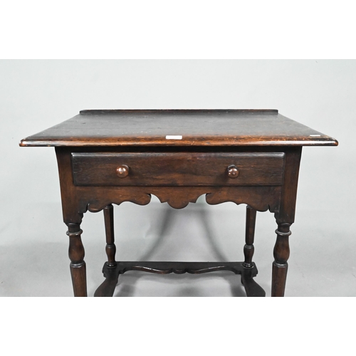 873 - A 17th century style provincial oak side table, with single frieze drawer, raised on turned legs uni... 