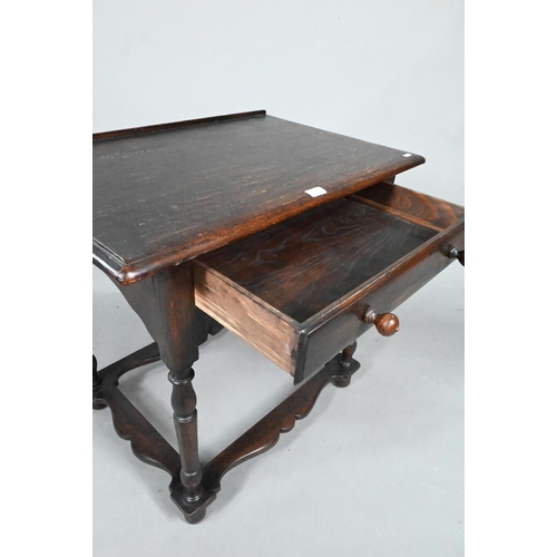 873 - A 17th century style provincial oak side table, with single frieze drawer, raised on turned legs uni... 