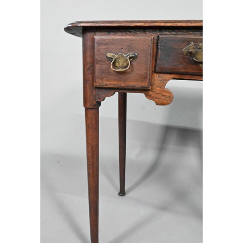 878 - An 18th century oak three drawer low boy side table, raised on slender turned tapering legs to pad f... 