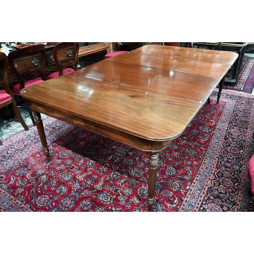 879 - A George III mahogany dining table, the pair of d-ends with twin gate-legs united by two extension l... 