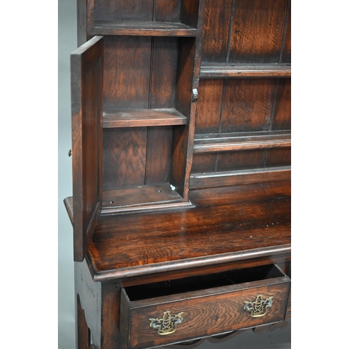 889 - An 18th century style oak high dresser, the rack with dentil moulted canopy centred by open shelves ... 