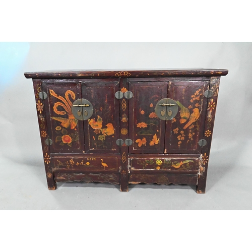 891 - An antique Chinese red laquer and polychrome decorated two door cabinet, presented in distressed con... 