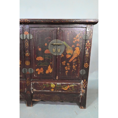 891 - An antique Chinese red laquer and polychrome decorated two door cabinet, presented in distressed con... 