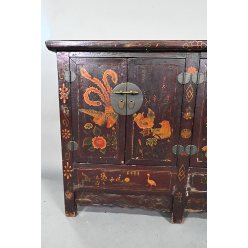 891 - An antique Chinese red laquer and polychrome decorated two door cabinet, presented in distressed con... 