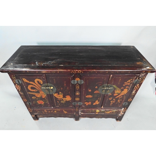 891 - An antique Chinese red laquer and polychrome decorated two door cabinet, presented in distressed con... 