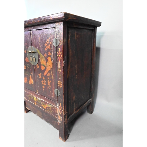 891 - An antique Chinese red laquer and polychrome decorated two door cabinet, presented in distressed con... 