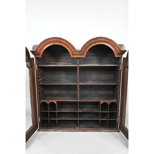 892 - A William & Mary period walnut double dome top cabinet, with pair of arched glazed doors enclosi... 