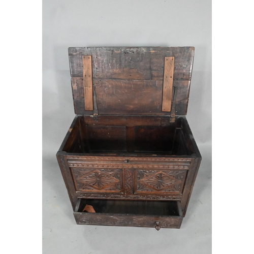 897 - An antique oak mule chest, the two plank top over a twin carved panel and conforming drawer, 90 cm w... 