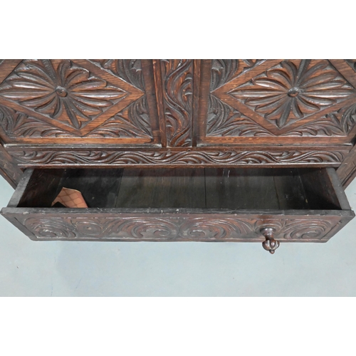 897 - An antique oak mule chest, the two plank top over a twin carved panel and conforming drawer, 90 cm w... 