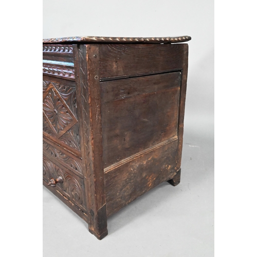 897 - An antique oak mule chest, the two plank top over a twin carved panel and conforming drawer, 90 cm w... 