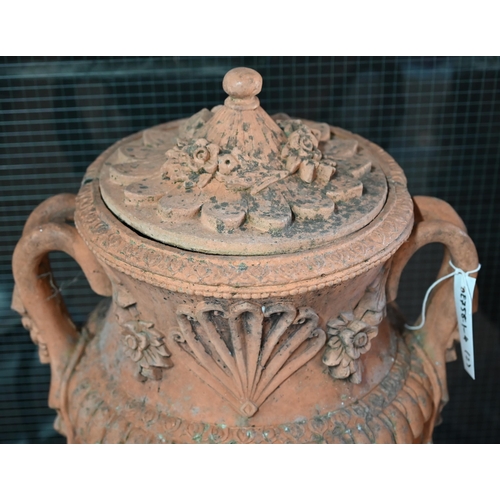 901 - A large pair of weathered classical cast terracotta lidded urns, with twin loop handles and decorate... 