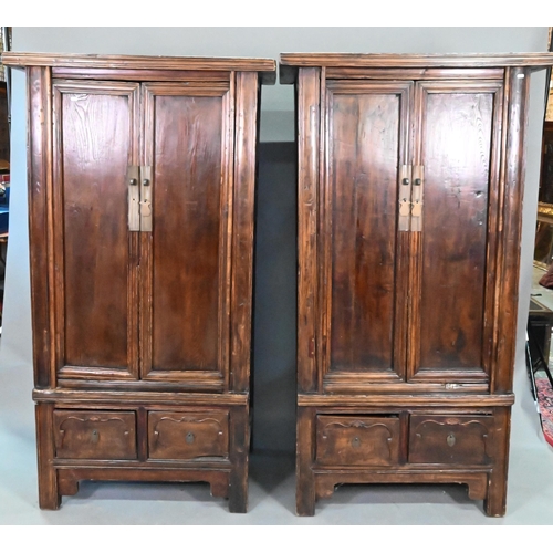 906 - A companion pair of Chinese Northern elm (Yumu) cabinets, late Qing, two doors over two drawers, 96 ... 