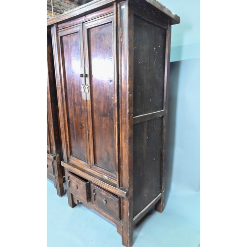 906 - A companion pair of Chinese Northern elm (Yumu) cabinets, late Qing, two doors over two drawers, 96 ... 