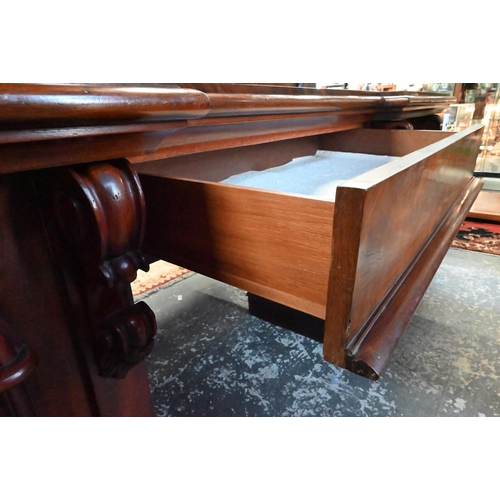 907 - A large Victorian mahogany country house twin pedestal sideboard, the heavily moulded back over a ce... 