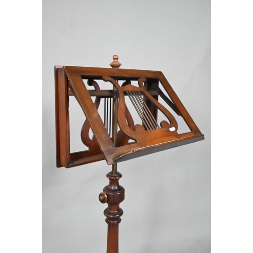 909 - A Victorian mahogany duet music stand, the adjustable lyre centred easels raised on a brass pole to ... 