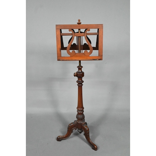 909 - A Victorian mahogany duet music stand, the adjustable lyre centred easels raised on a brass pole to ... 