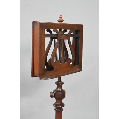 909 - A Victorian mahogany duet music stand, the adjustable lyre centred easels raised on a brass pole to ... 