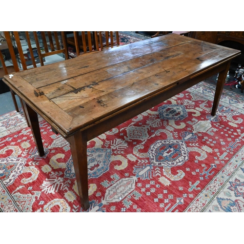 913 - An antique French fruitwood extending draw leaf dining table, with frieze drawer to one end, raised ... 