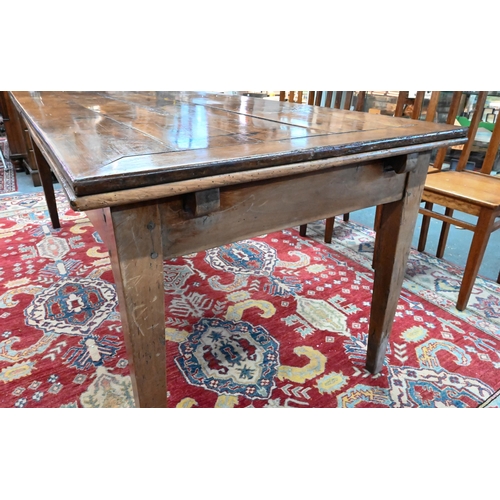 913 - An antique French fruitwood extending draw leaf dining table, with frieze drawer to one end, raised ... 