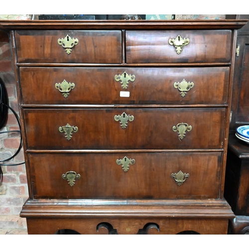 915 - An 18th century and later oak and walnut chest on stand, two short over three long graduated drawers... 