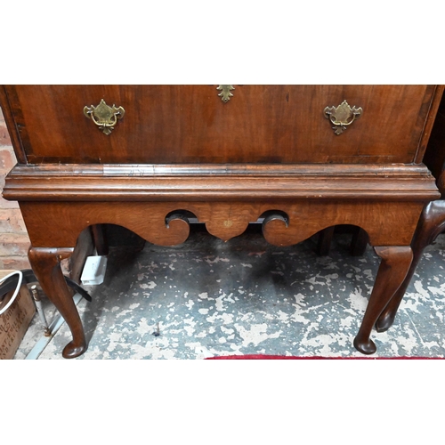 915 - An 18th century and later oak and walnut chest on stand, two short over three long graduated drawers... 