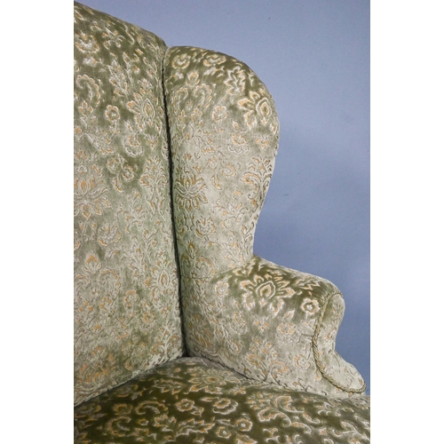 917 - An oak framed upholstered Wing armchair, 19th century, raised on cabriole front legs united by stret... 