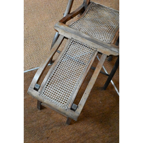 922 - An Edwardian beech framed folding steamer chair, with caned panels and foot extension