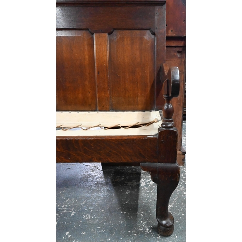 926 - An 18th century oak panel backed settle, with shaped arms over a rope and canvas seat (cushion inclu... 