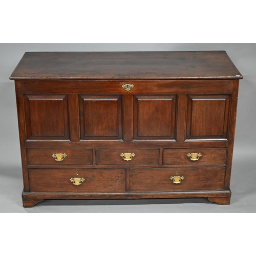 930 - A George III oak mule chest, the wide plank hinged top over four fielded panels, three short and two... 