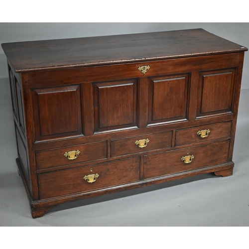 930 - A George III oak mule chest, the wide plank hinged top over four fielded panels, three short and two... 