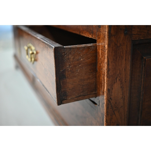 930 - A George III oak mule chest, the wide plank hinged top over four fielded panels, three short and two... 