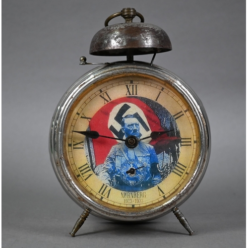 949 - A WWII period Nuremburg rally clockwork alarm clock, the dial with portrait of Adolf Hitler before a... 