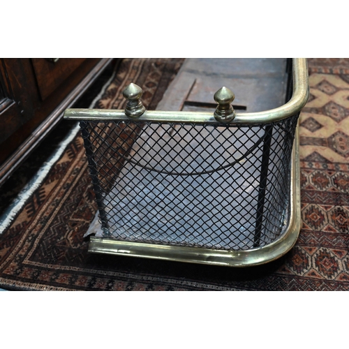 967 - An antique brass framed and diamond wire mesh fire fender, with steel base trough, overall 96 cm w x... 