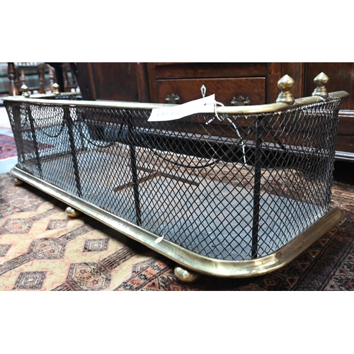 967 - An antique brass framed and diamond wire mesh fire fender, with steel base trough, overall 96 cm w x... 