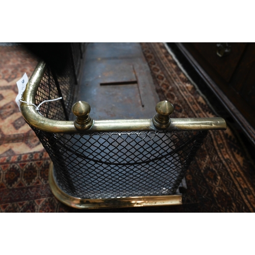 967 - An antique brass framed and diamond wire mesh fire fender, with steel base trough, overall 96 cm w x... 