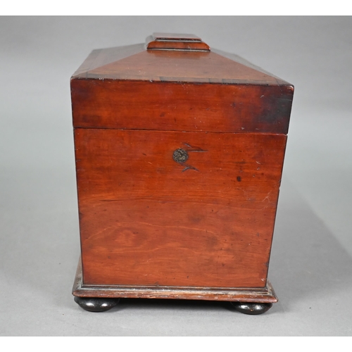 969 - A Regency mahogany sarcophagus form tea caddy, the interior with twin lidded boxes flanking a centre... 