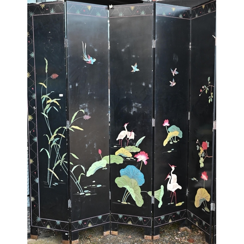 527 - A substantial early 20th century Chinese eight-panel folding screen or room divider, the black lacqu... 