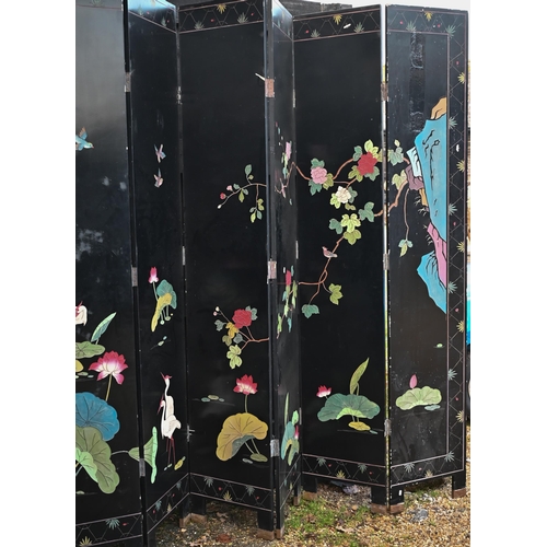 527 - A substantial early 20th century Chinese eight-panel folding screen or room divider, the black lacqu... 