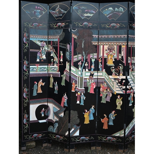 527 - A substantial early 20th century Chinese eight-panel folding screen or room divider, the black lacqu... 