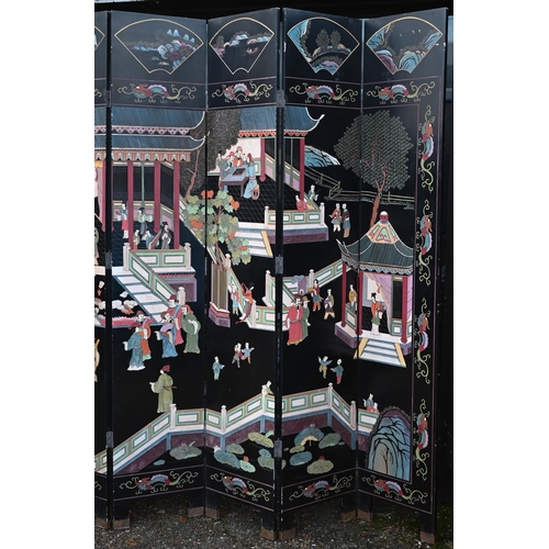 527 - A substantial early 20th century Chinese eight-panel folding screen or room divider, the black lacqu... 