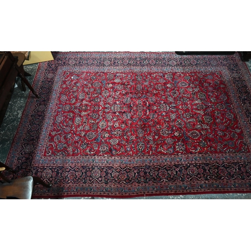 836 - A fine old Persian hand-made Kashan carpet, the red ground with repeating linked garden vine design,... 