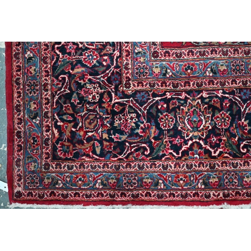 836 - A fine old Persian hand-made Kashan carpet, the red ground with repeating linked garden vine design,... 